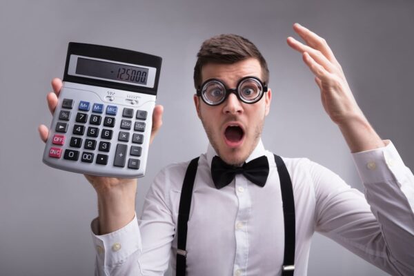 Get Real About Mortgages - Surprised man holding a calculator